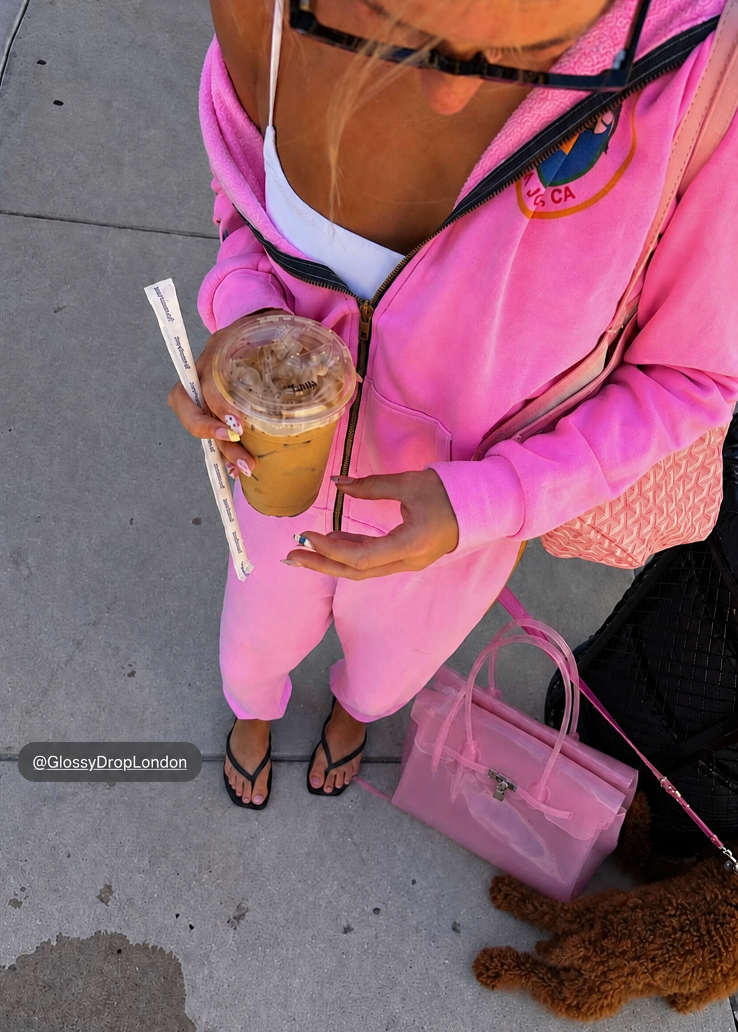 Pink jelly bag styled with a pink tracksuit and iced coffee